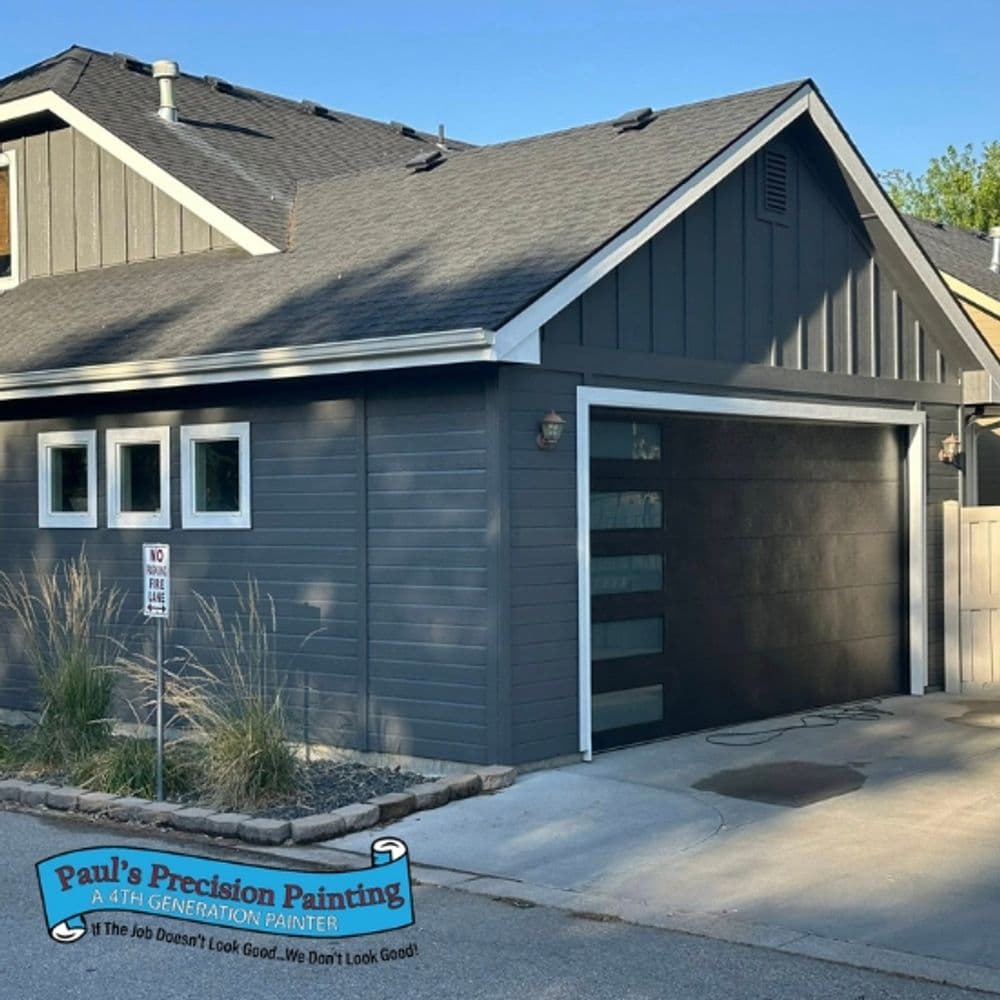 Modern grey house exterior with garage, featuring professional painting by Paul's Precision Painting.