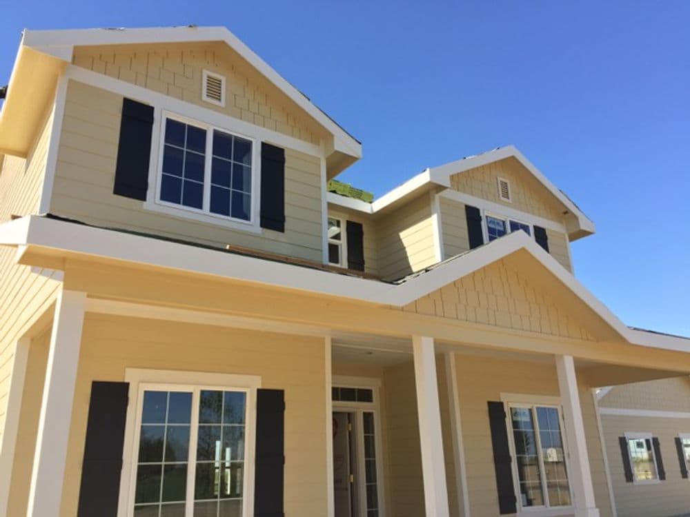 Newly built two-story house featuring modern architecture and large windows.